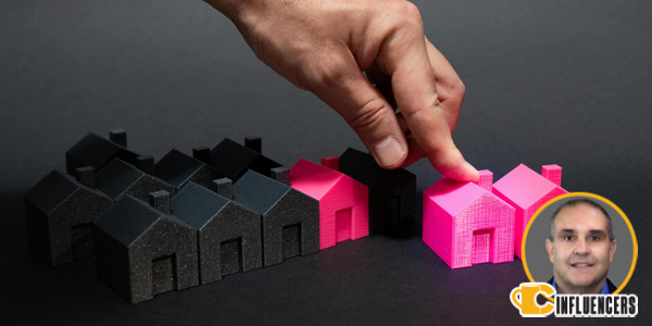 Image of a hand moving a pink house miniature. In the background are similar houses in black. John Kenney Image of a hand moving a pink house miniature. In the background are similar houses in black. John Kenney